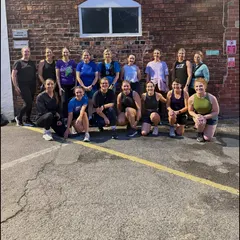 Lews Fitness run club outside the gym on Dale Street